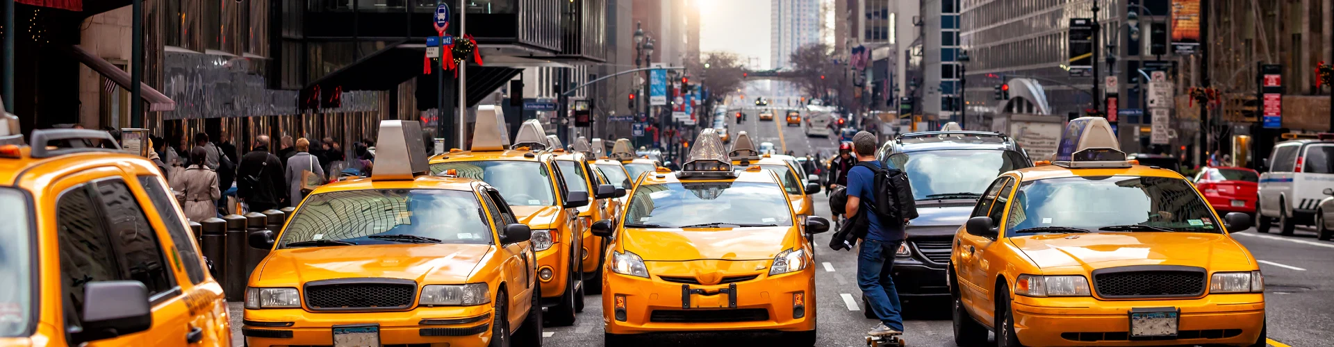 A bustling New York City street filled with yellow taxis and pedestrians, showcasing the urban energy and traffic.